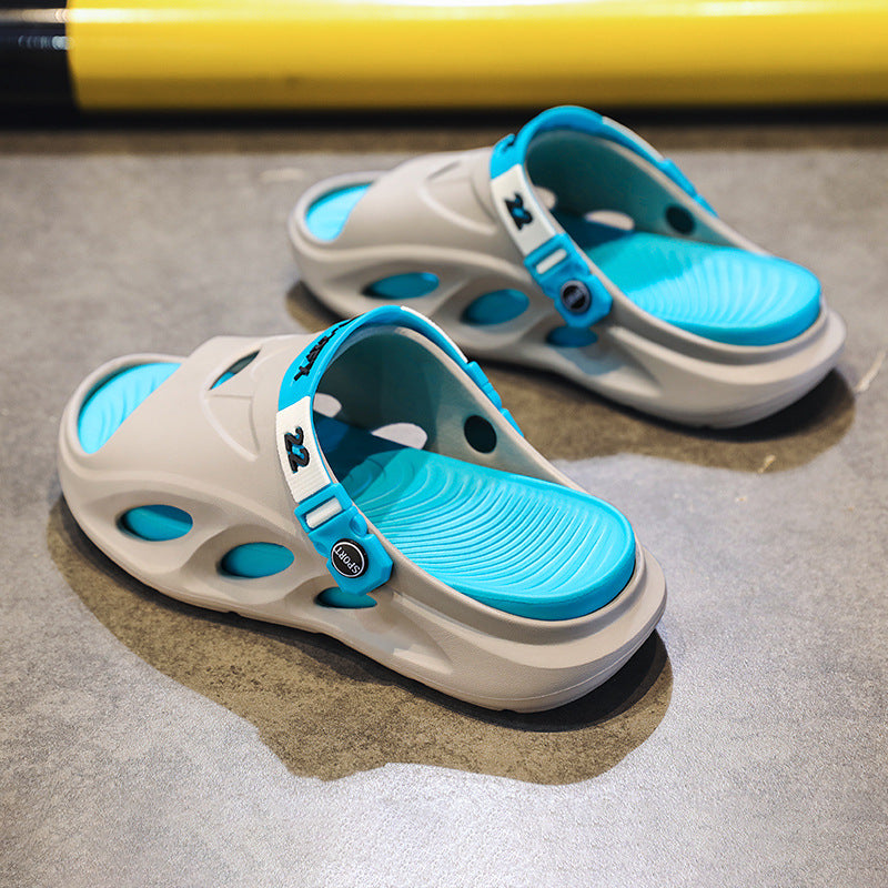 Gray slide sandals with blue footbed and blue adjustable strap, openwork upper