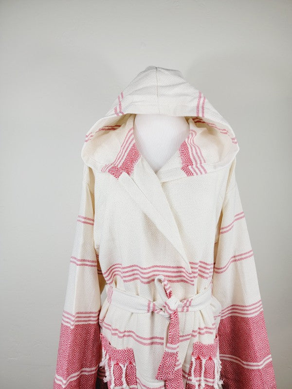 Unisex hooded bathrobe in cream with pink striped accents, tied belt at waist, long sleeves.