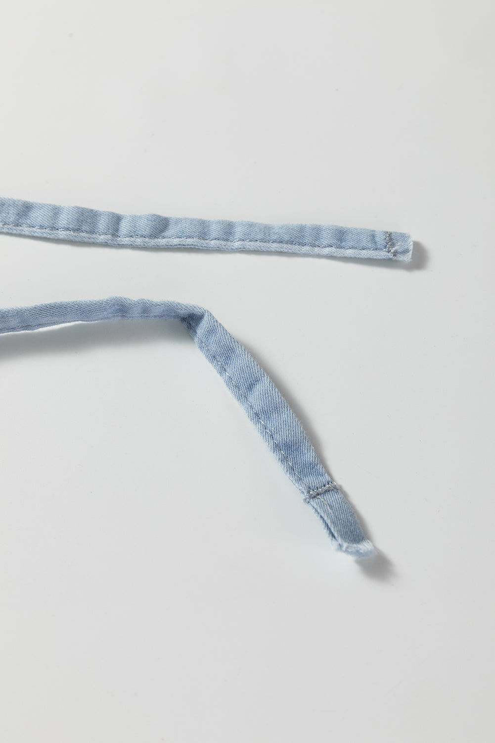 Sky blue stripe trouser waistband with drawstring tie end