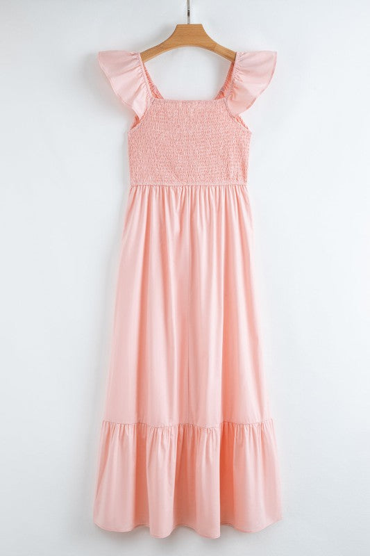 Apricot pink maxi dress on hanger with smocked bodice and tiered skirt