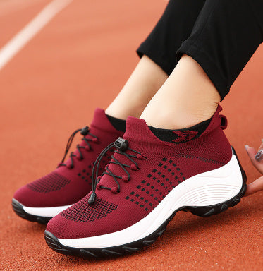 Burgundy knit sock-style athletic sneaker with black laces and white cushioned sole