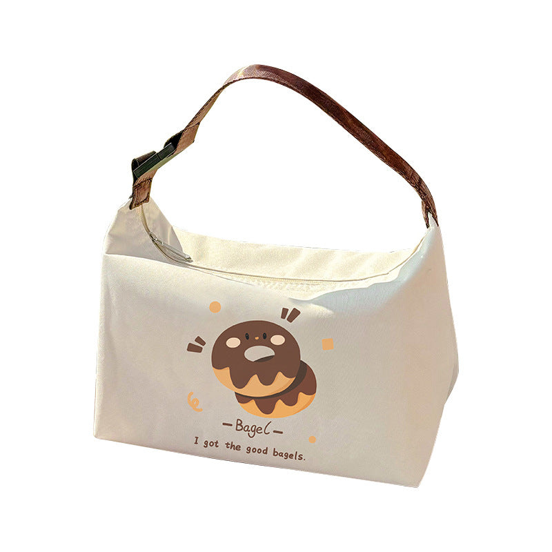 Insulated lunch bag in off-white with brown dog-and-bagel cartoon print and strap