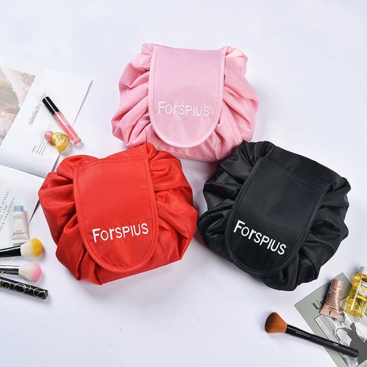 Pink waterproof drawstring toiletry bag with front pouch and gathered sides