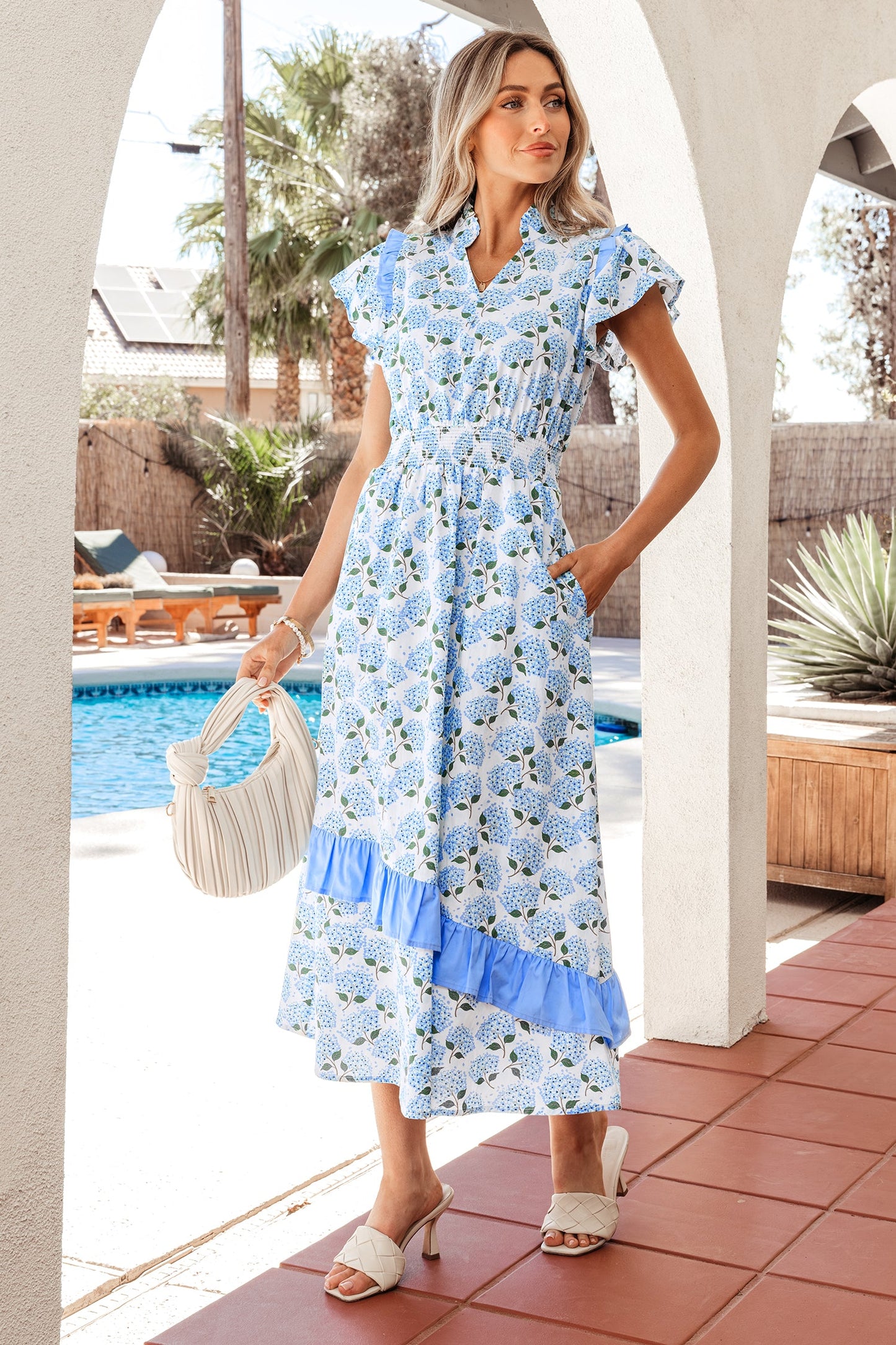 Sky blue long dress with flutter sleeves, V-neck, and tiered ruffle skirt in floral print
