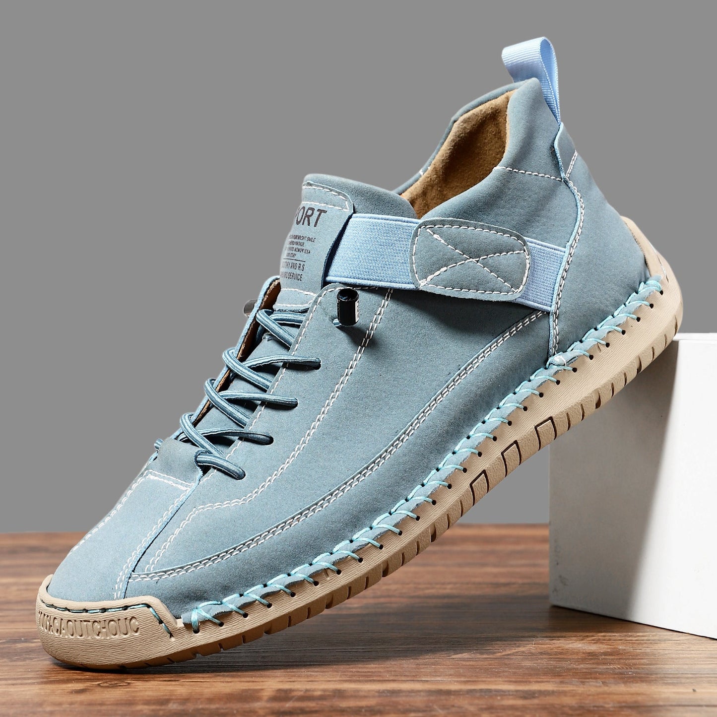 Casual leather boots in light blue with lace-up front, side strap, and stitched tread sole.