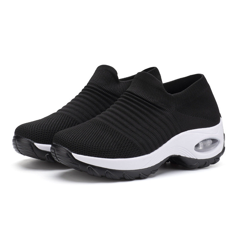 Black knit slip-on sneakers with white sole and air-cushioned heel