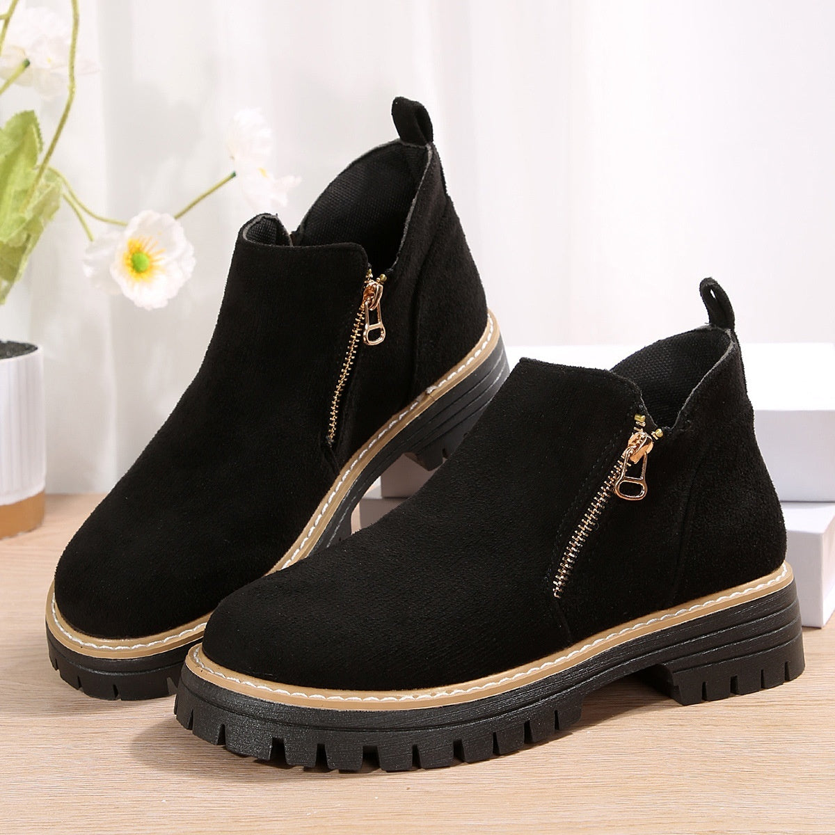 Black suede ankle boots with side zipper and chunky black lug sole