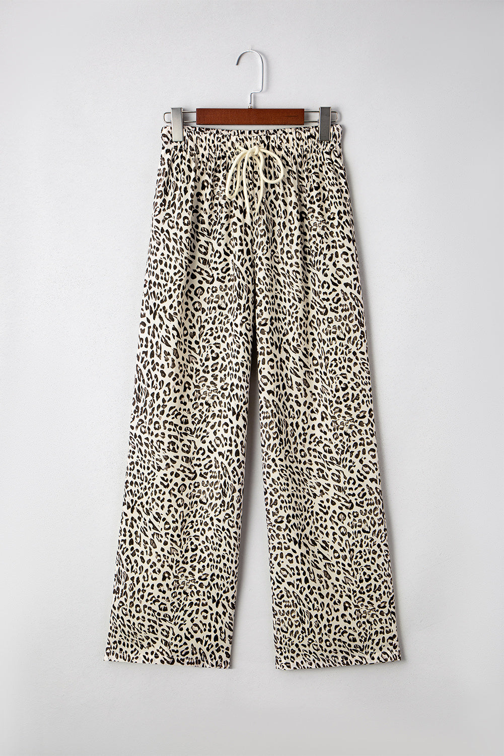 Leopard print loose pants on hanger, drawstring elastic waistband, brown and cream.