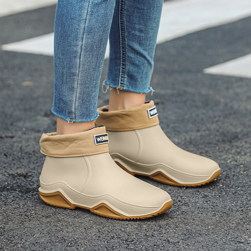 Men's short rain boots, cream with tan outsole, slip-on ankle style with logo patch