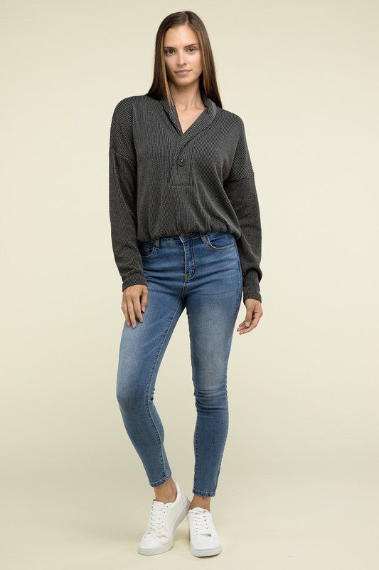 Black textured knit pullover top with button V-neck and relaxed fit, long sleeves