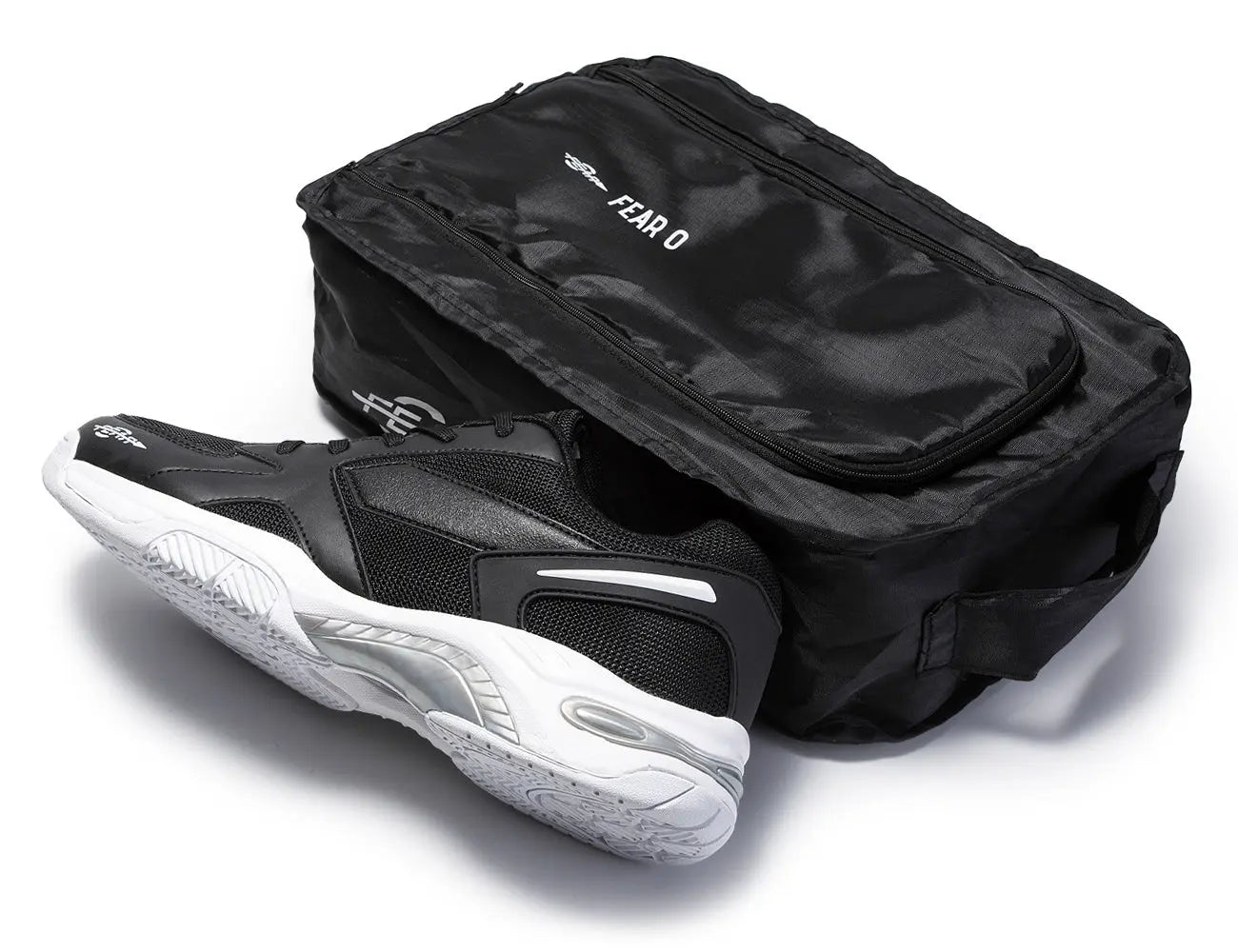 Men’s black walking shoe next to black reusable shoe bag with zipper