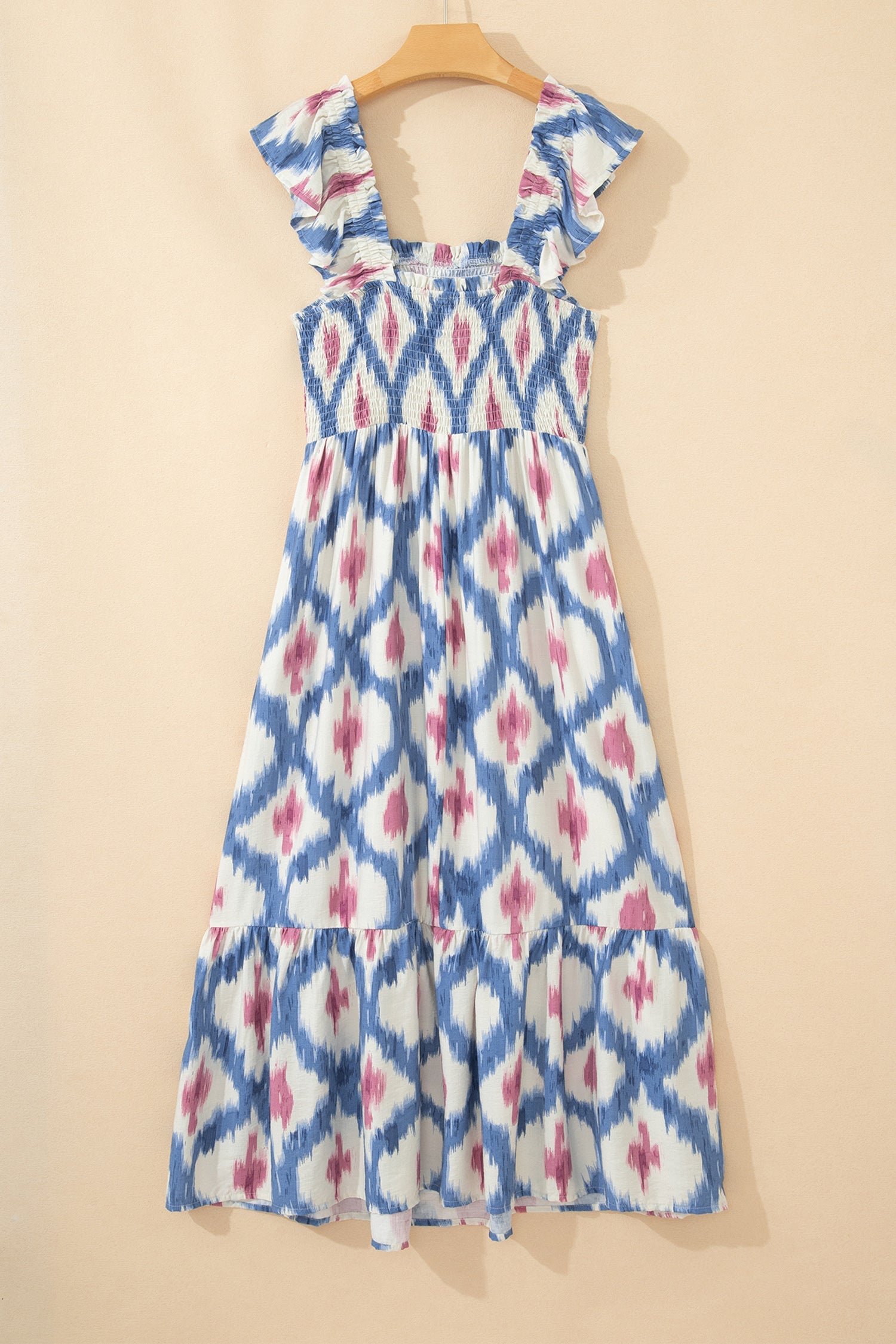 Sky blue ikat-pattern midi dress on hanger with tiered skirt