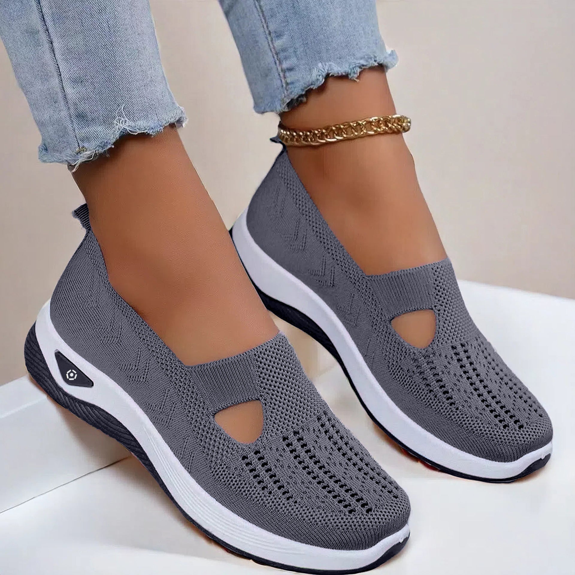 Dark gray knit mesh slip-on flats with round cutout and white cushioned sole