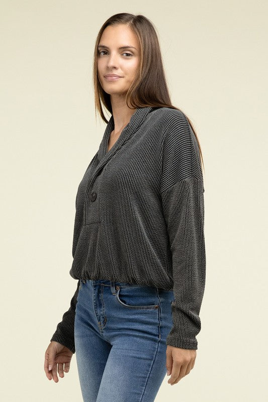 Black textured knit pullover top with shawl collar, button front pocket, long sleeves