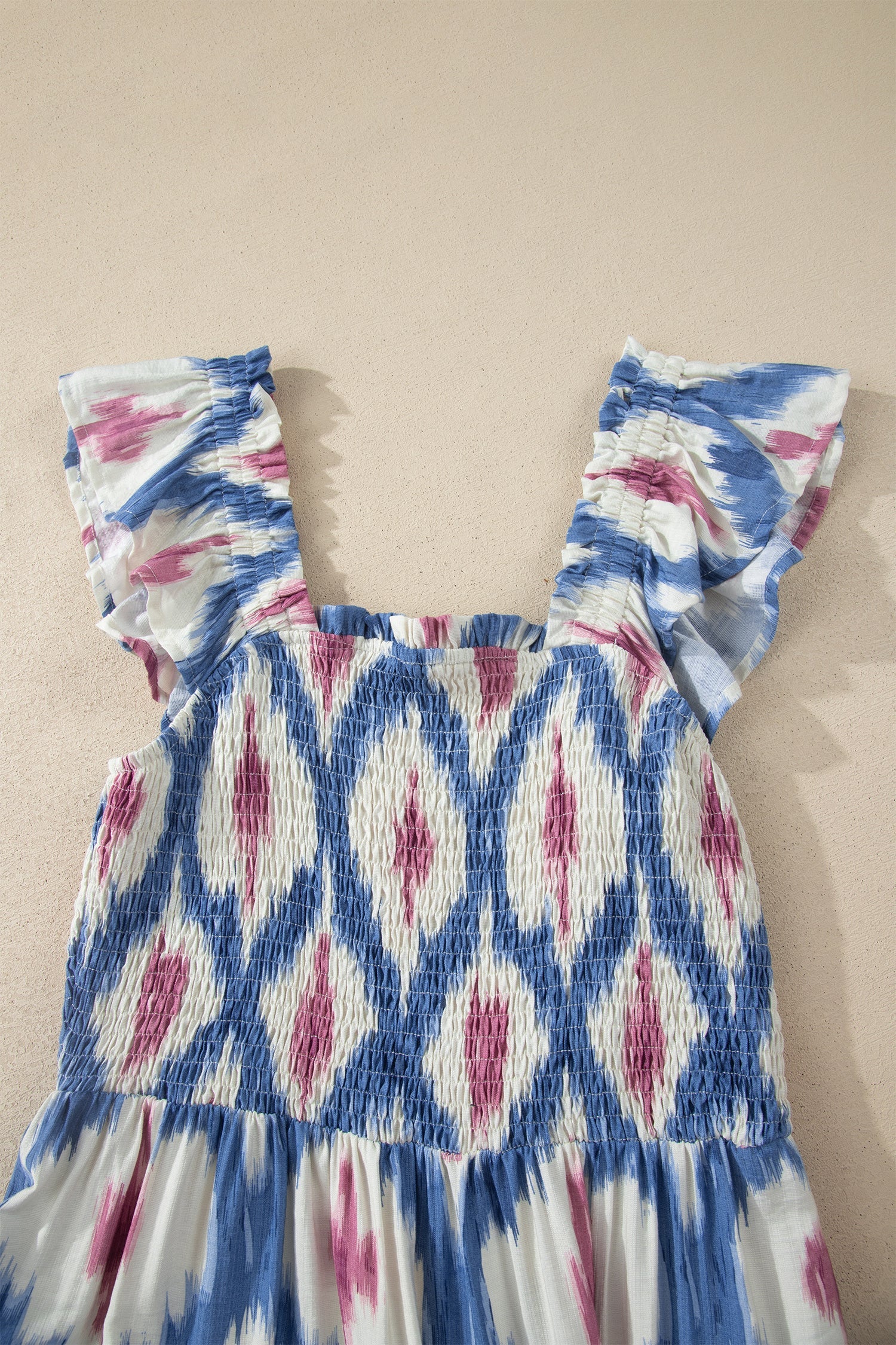 Sky blue ikat-pattern dress top with ruffle cap sleeves and smocked neckline