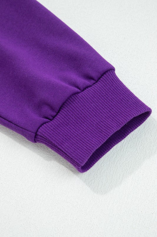 Purple pullover sleeve cuff with ribbed knit and stitched band