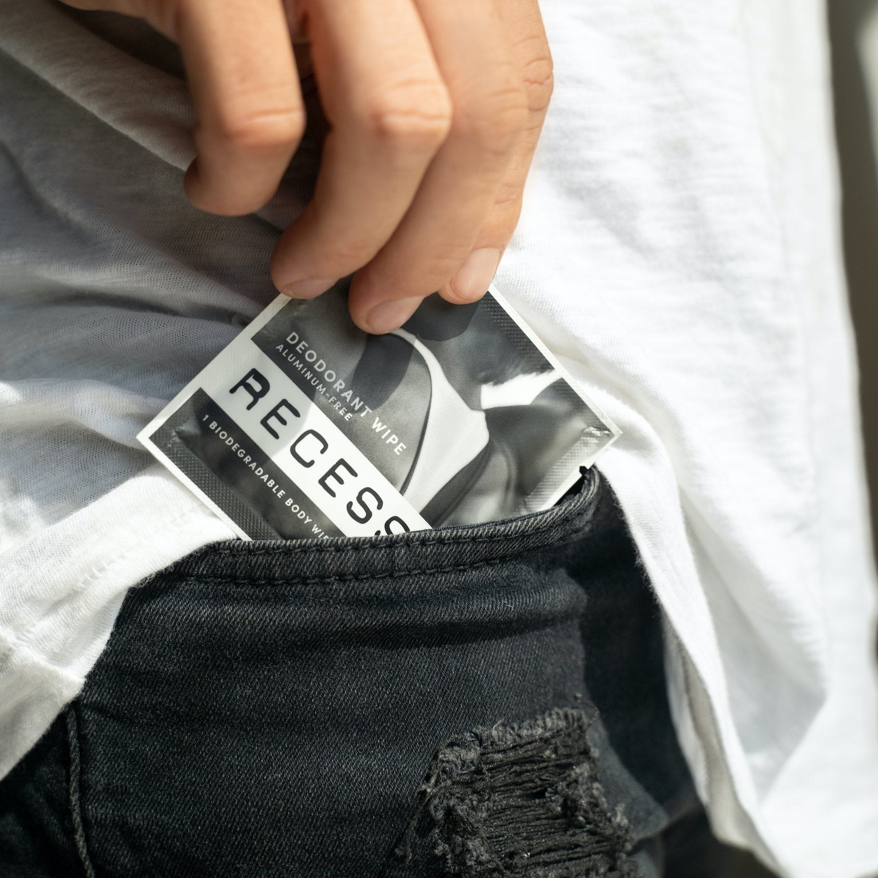 Person holding a package of Recess deodorant in their pocket.