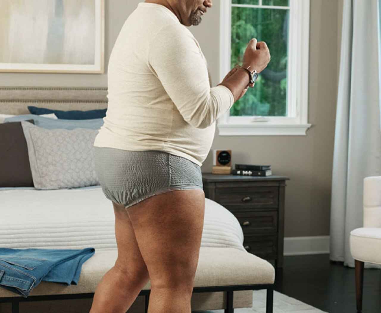 Men's protective brief underwear, light blue-gray, worn under a cream long-sleeve shirt