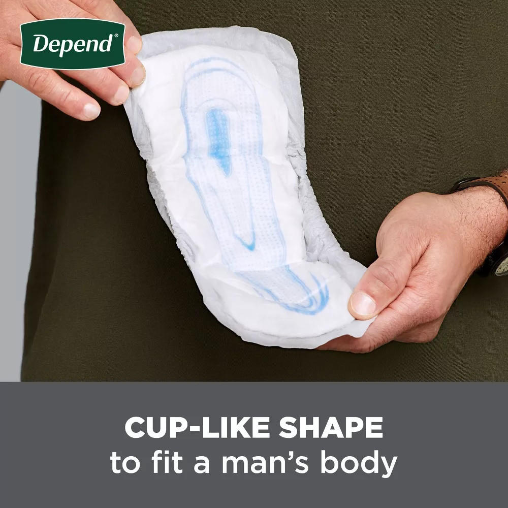 White men’s incontinence guard with cup-like shape held in hands