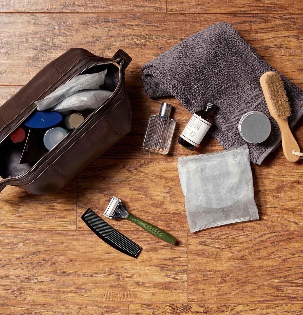 Personal care items in a zip pouch and on a wooden surface