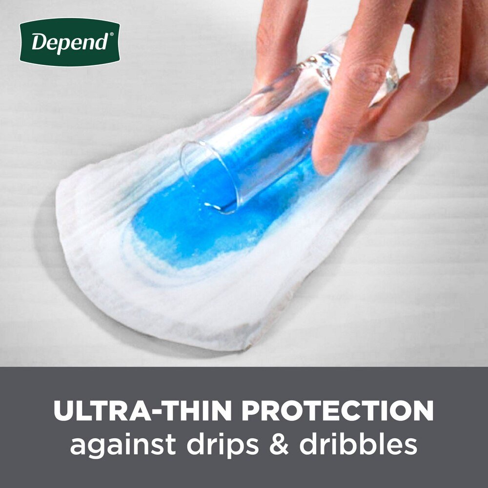 White men’s incontinence shield with blue absorbent pad, held by hand