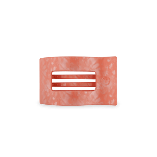 Peach flat rectangle hair clip with three horizontal slots and small embossed logo