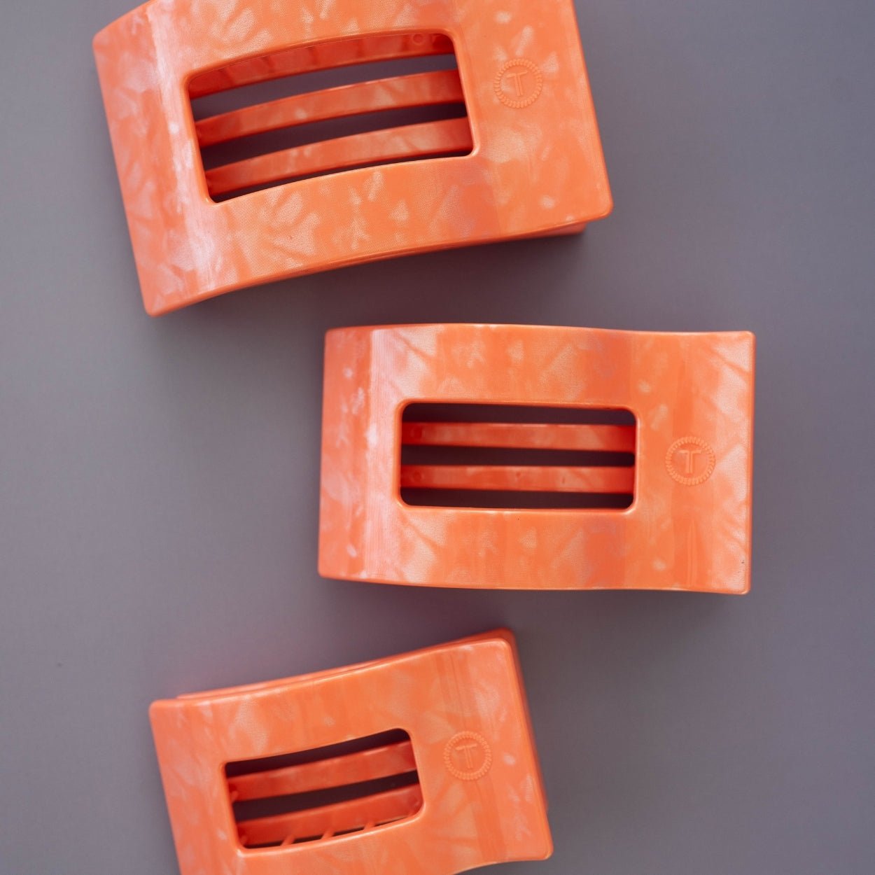 Set of three peach flat rectangle hair clips with horizontal slots