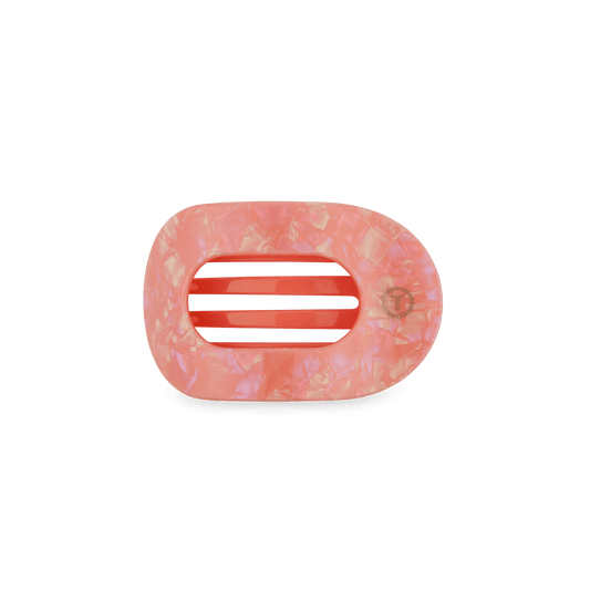 Pink flat oval hair clip with textured finish and red-striped center prongs
