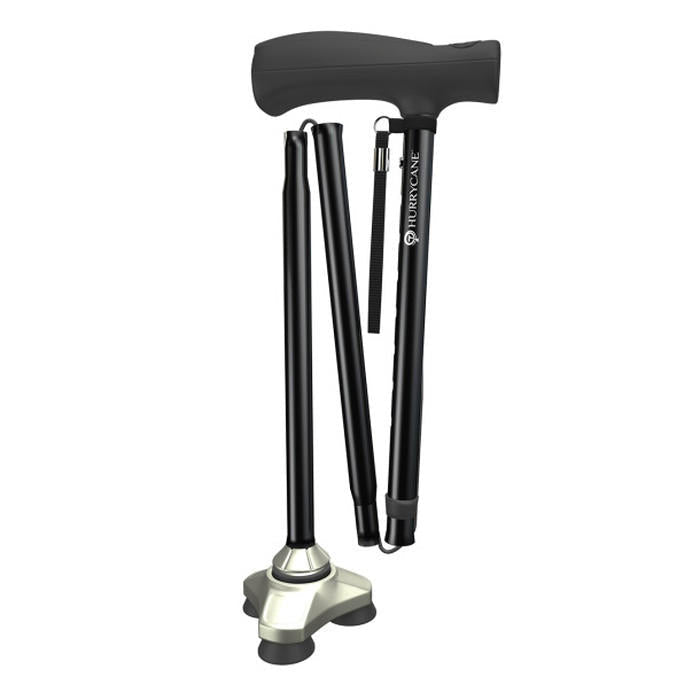 Black folding cane with stacked folded legs and wrist strap at handle