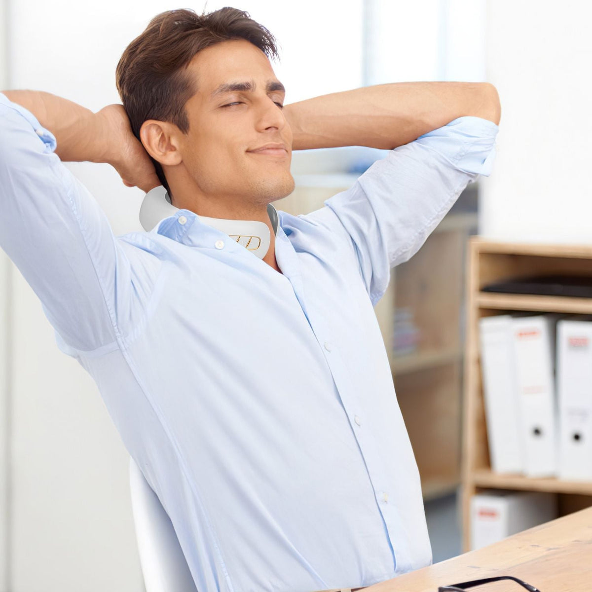 Wireless cervical neck massager worn on a man's neck with heated massage pads