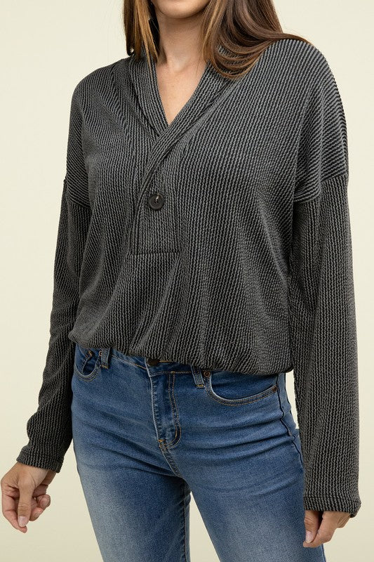 Black textured knit pullover top with V-neck shawl collar and button placket, long sleeves