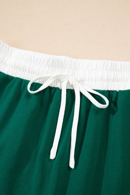 Green mini skirt with elastic waist and white drawstring ties