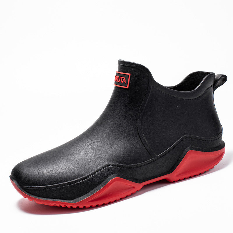 Black low-top rubber rain boot with red outsole and thick tread sole