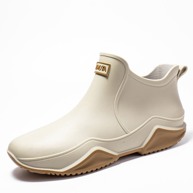 Beige low-top rubber rain boot with tan outsole and thick tread