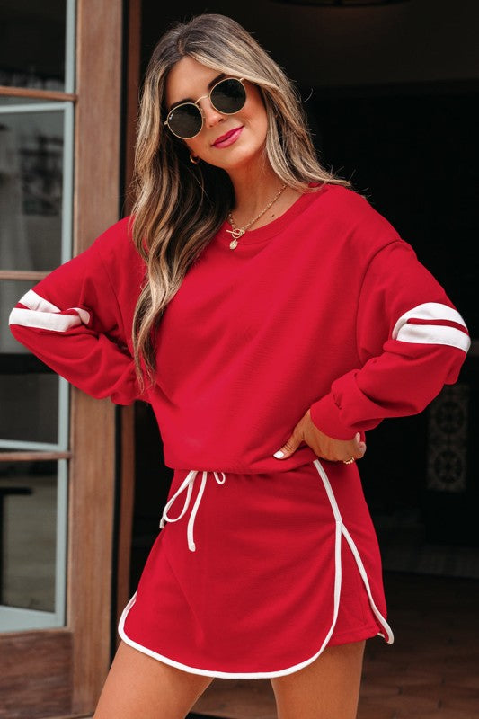 Red pullover top and mini skirt set with white striped sleeves and lace-up drawstring waist