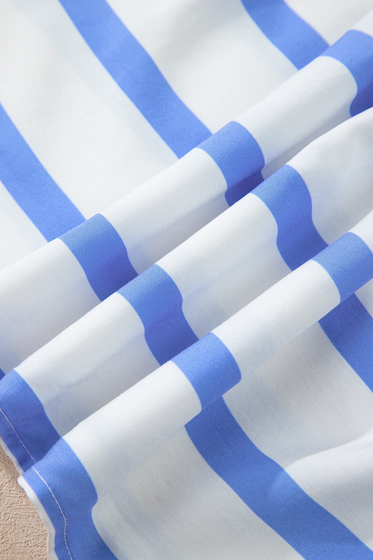 Close-up of blue-and-white striped fabric with lightweight drape