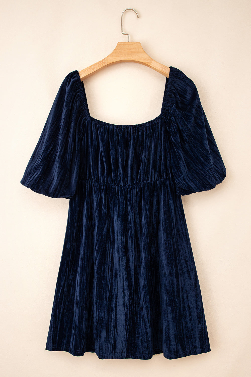 Navy blue short dress on hanger with square neckline and gathered waist