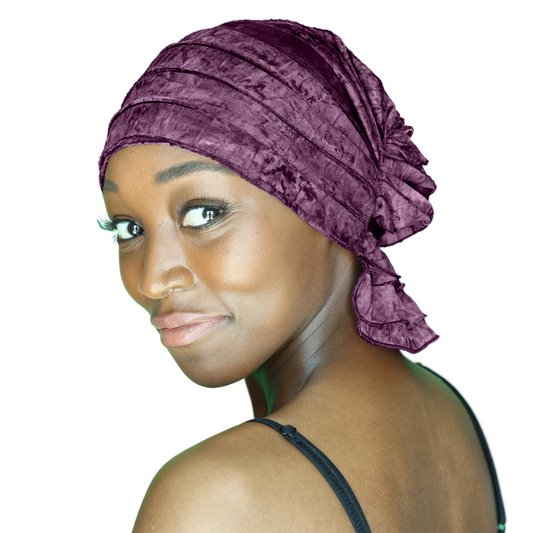 Purple chemo beanie cap with layered ruffles and tied side bow