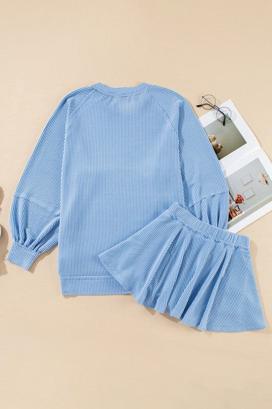 Light blue corded top and ruffle mini skirt set, long sleeves, flat lay