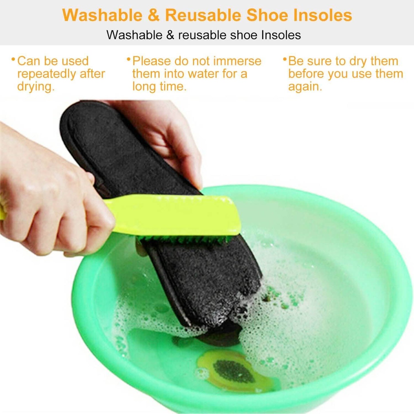 Black washable heated insoles being rinsed in a basin with water