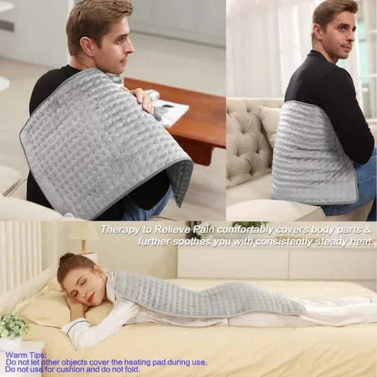 Gray washable heating pad folded and held, with a person using it on a sofa seat