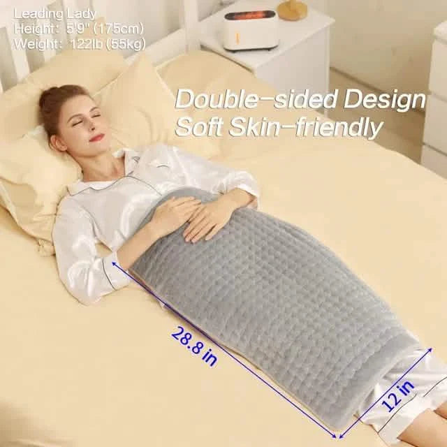 Gray heated blanket pad with double-sided design label while a person lies down