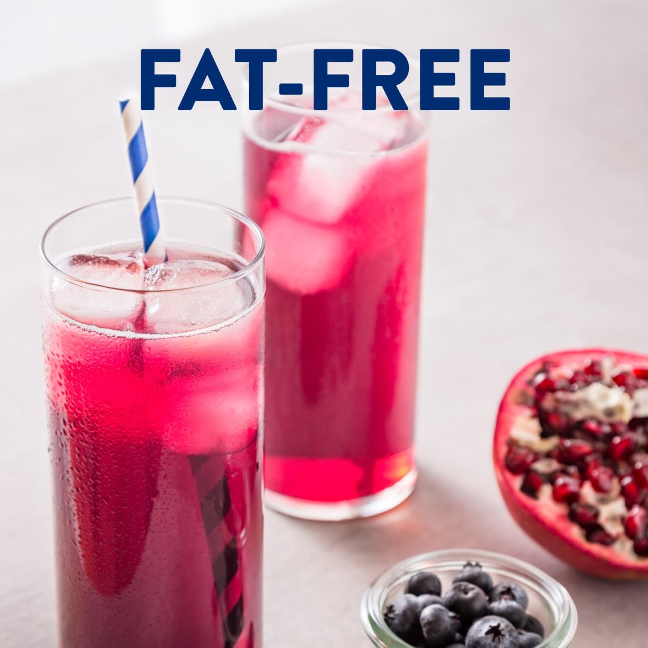 Fat-free nutrition drink with blueberry and pomegranate flavors; bottle and glass