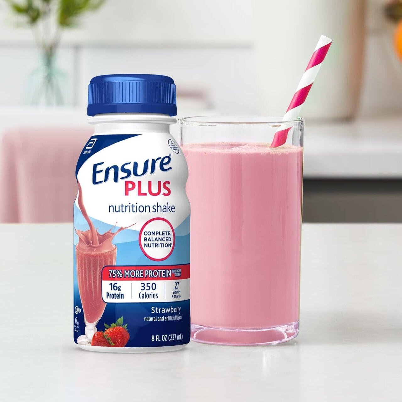 Ensure Plus strawberry shake bottle with glass of pink smoothie
