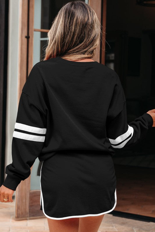 Back view of black varsity stripe pullover and mini skirt set, showing white sleeve stripes.