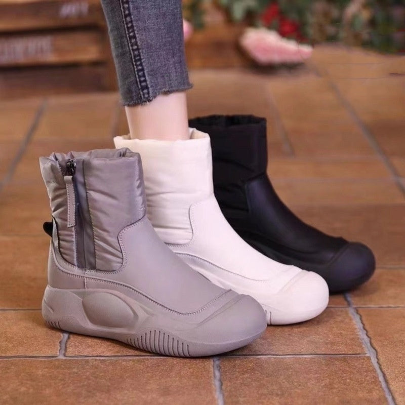 Grey and white winter snow boots, side zipper, thick tread sole.