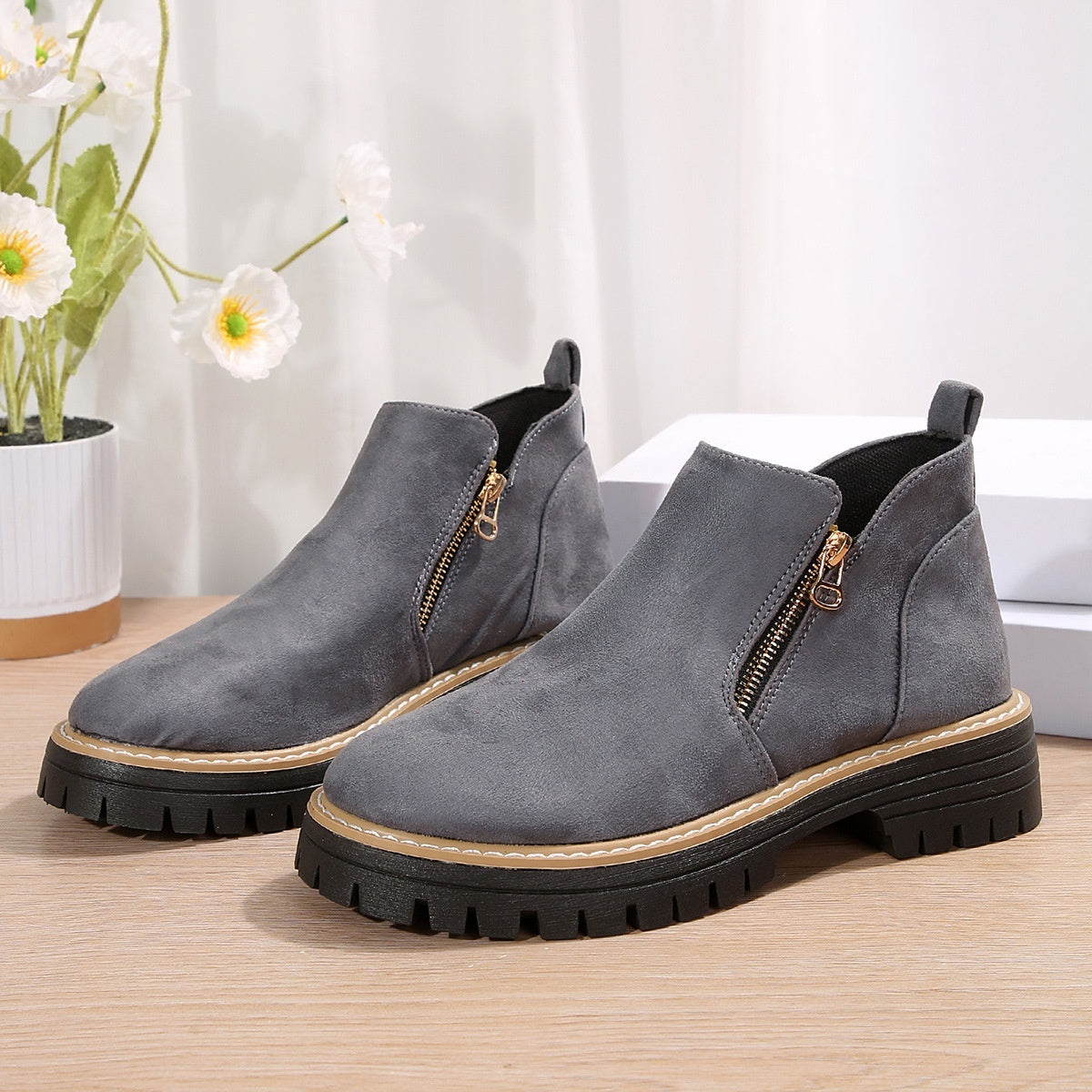 Gray suede ankle boots with side zipper and chunky black lug sole