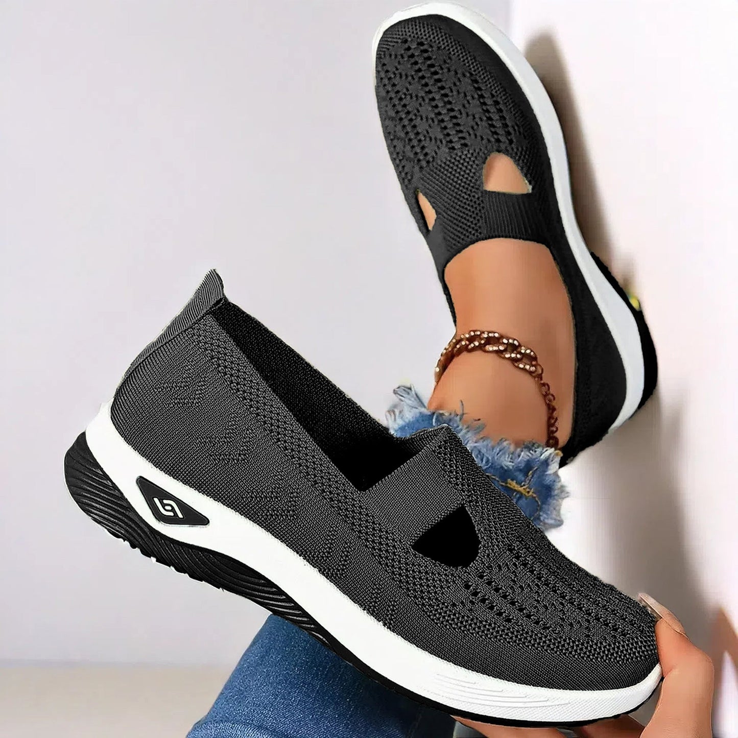 Black knit mesh flats with oval cutout and white sole, slip-on casual shoes