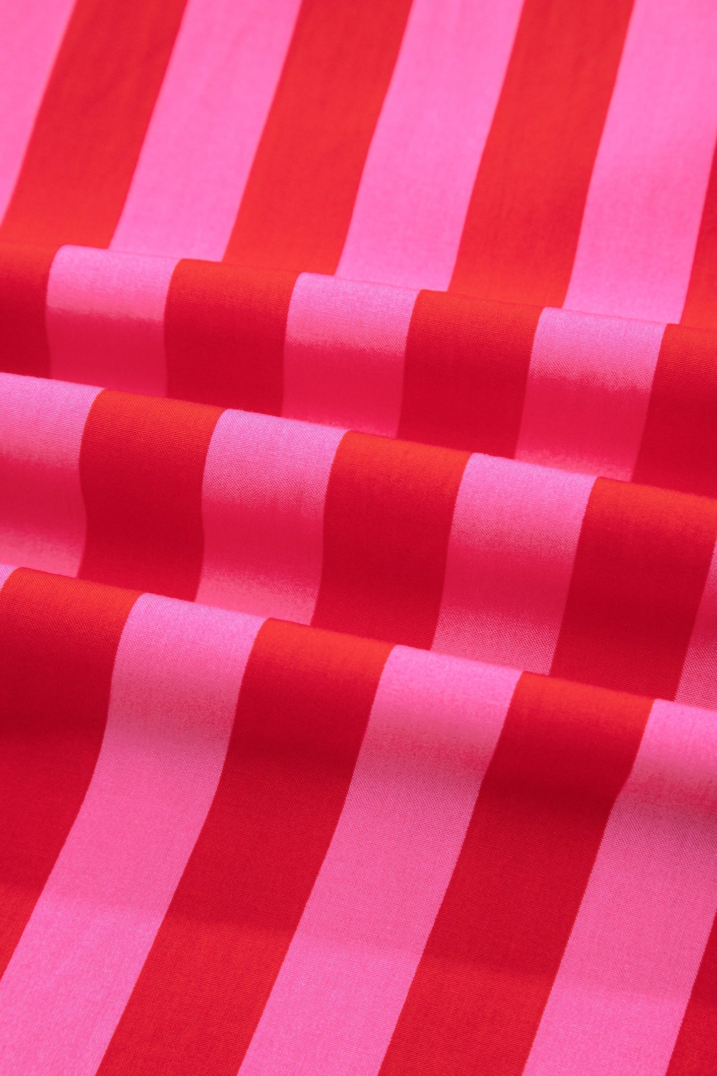 Close-up of pink and red vertical striped fabric