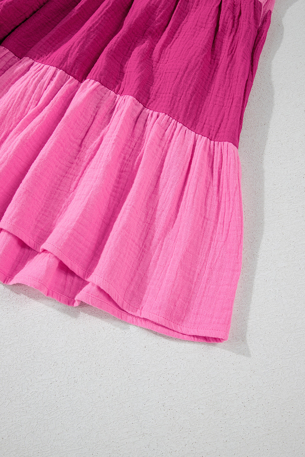 Pink tiered mini dress close-up of hem and gathered tiers
